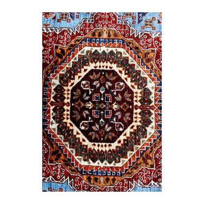 Close central medallion detail of Afghan Mamluk hand-knotted wool rug showing ivory, rust red, dark brown and blue patterning
