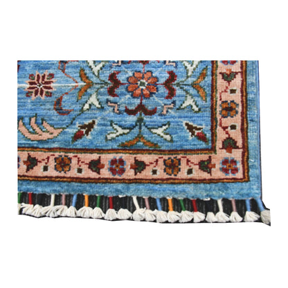 End border and fringe detail of Afghan Mamluk hand-knotted wool rug showing sky-blue field, patterned border and tassel fringe