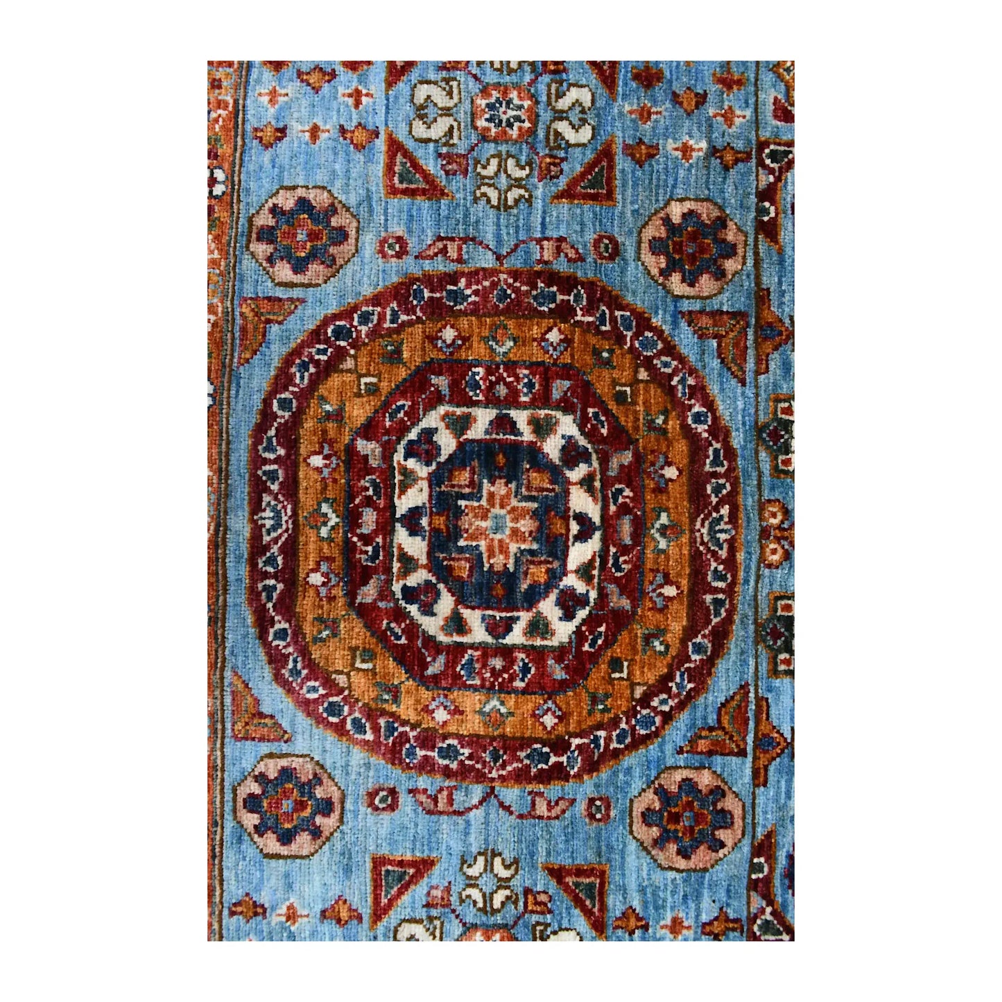 End medallion and field detail of Afghan Mamluk hand-knotted rug showing blue ground, circular motif and surrounding floral details