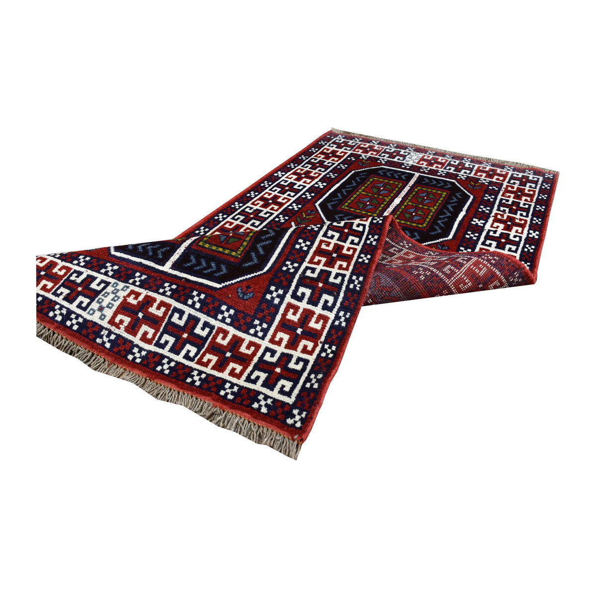Folded view of Afghan Mashwani rug showing its patterned wool pile, geometric field, ivory border and fringe