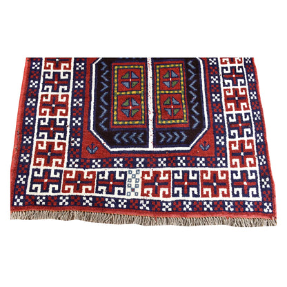 End section of Afghan Mashwani rug showing a geometric medallion, ivory angular border and pale fringe