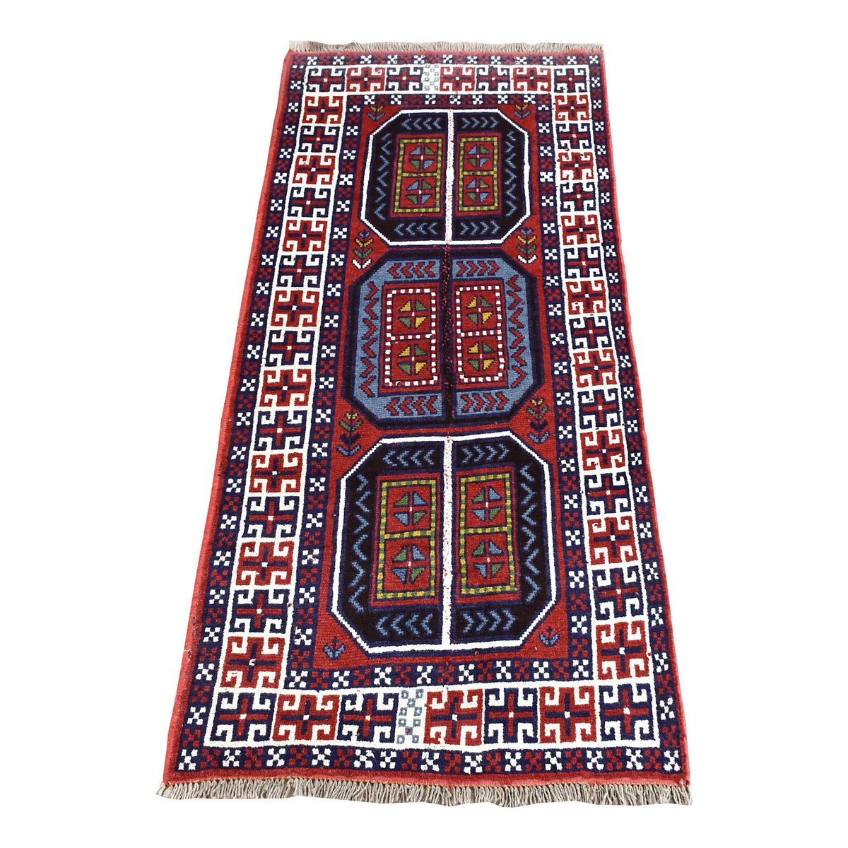 Full view of Afghan Mashwani rug with three red and navy geometric medallions and an ivory meander border, 218 x 107 cm
