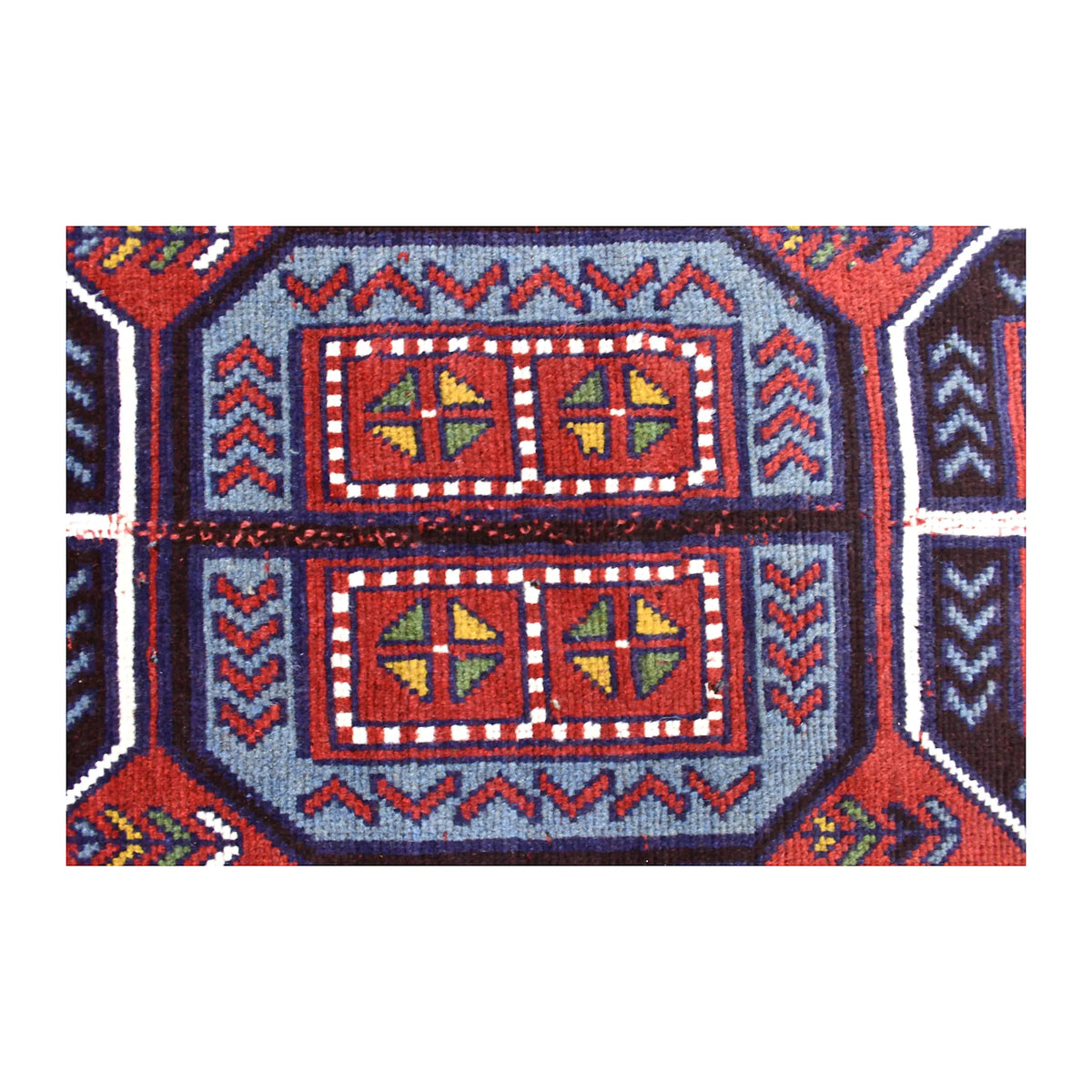 Medallion detail of Mashwani rug with four quartered red, olive and ochre motifs inside pale blue stepped outlines
