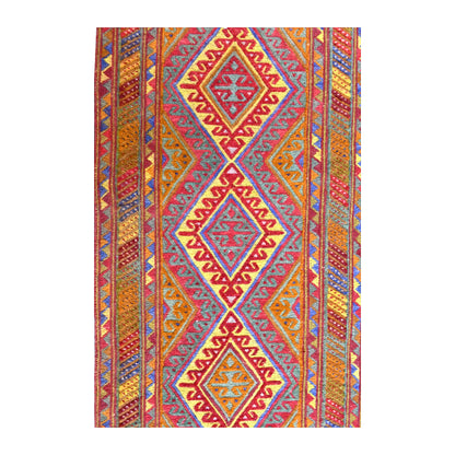 Field detail of Afghan Mashwani wool runner showing repeating diamond medallions in rust, red, mustard, turquoise and blue