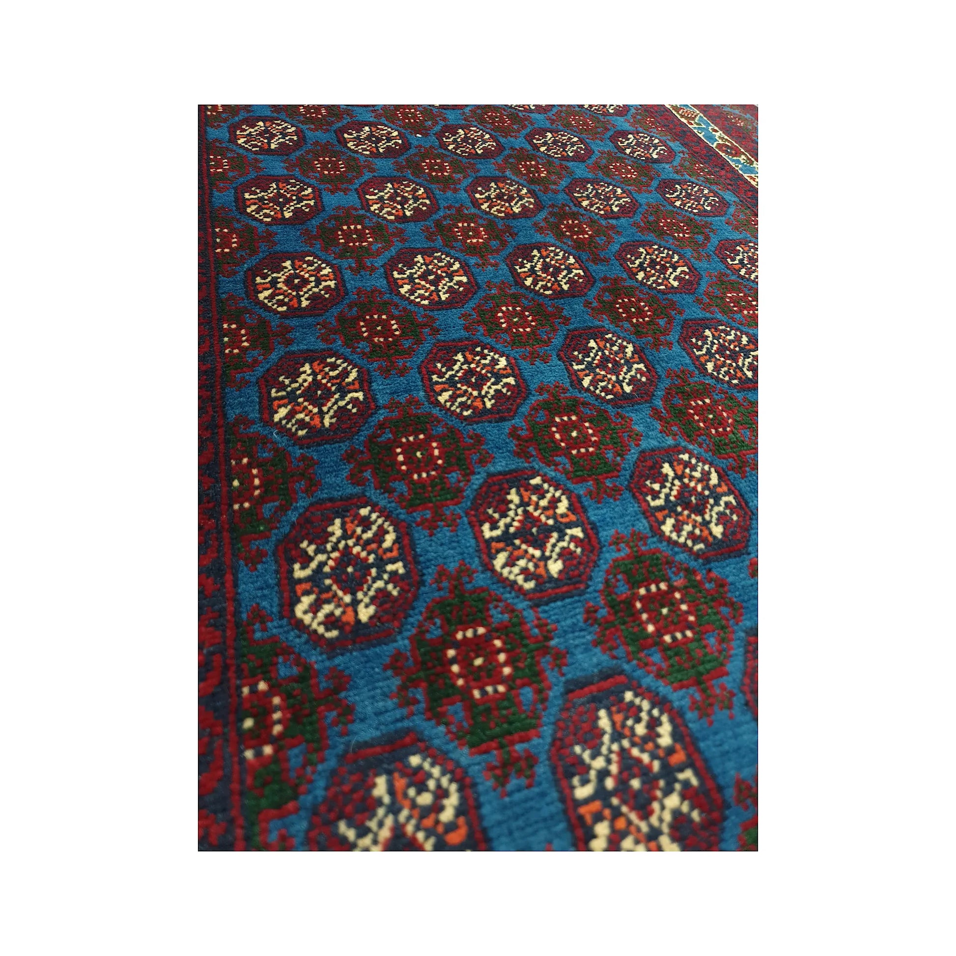 Angled field motif detail of Afghan Roshnai runner rug with blue wool pile and repeating burgundy medallions