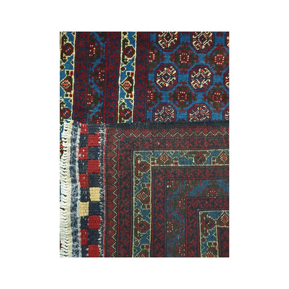Folded corner detail of Afghan Roshnai runner rug showing the back of the rug, fringe and blue front pattern