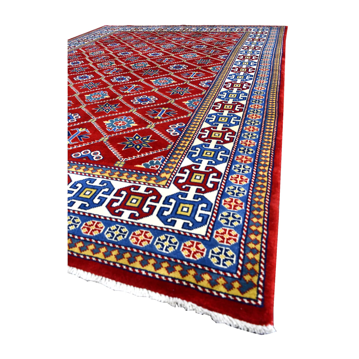 Angled view of Afghan Shirvan wool rug showing its red geometric field, layered blue and ivory borders and pale fringe