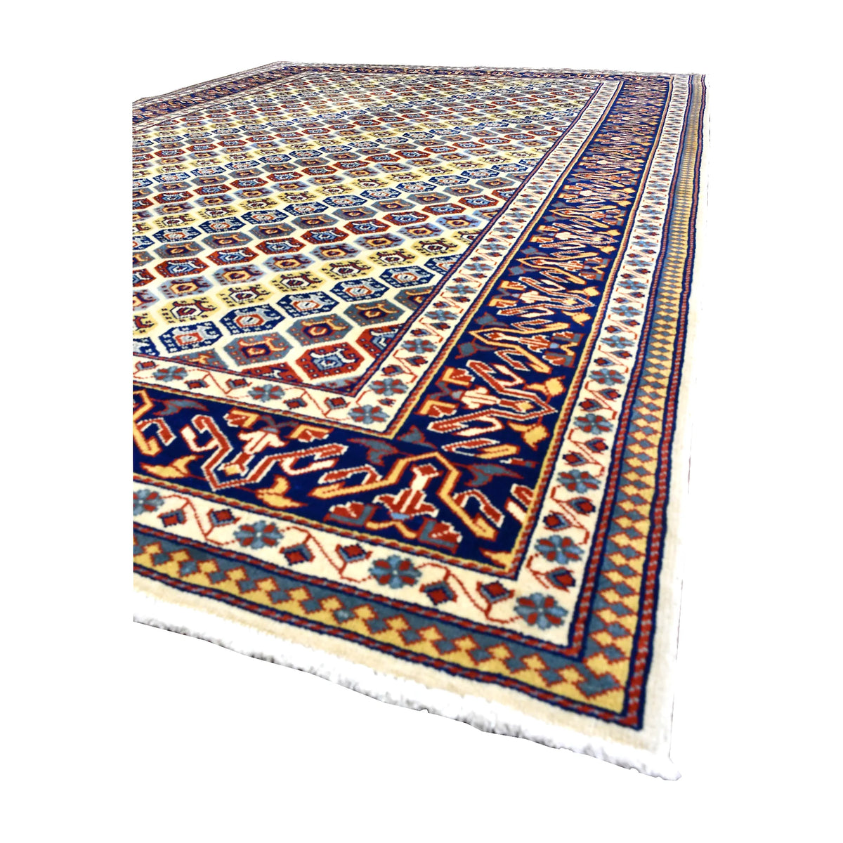 Angled view of Afghan Shirvan wool rug showing its intricate geometric field, deep navy border, wool pile and pale fringe