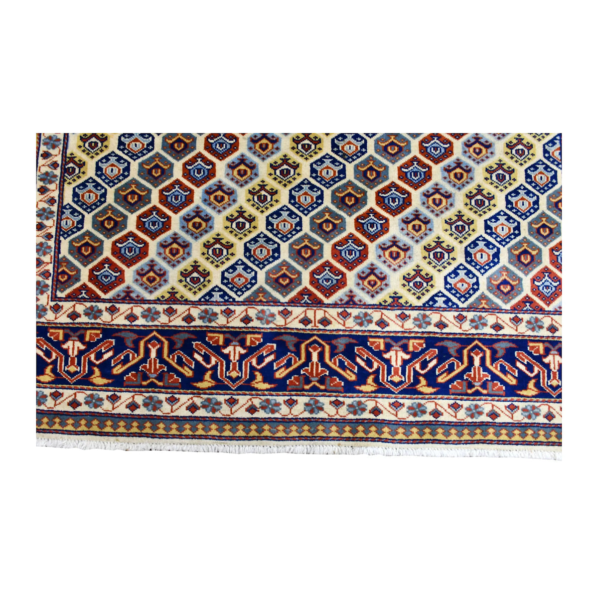 Fringe and end-border detail of Afghan Shirvan rug with navy, rust red, ivory and muted gold patterning