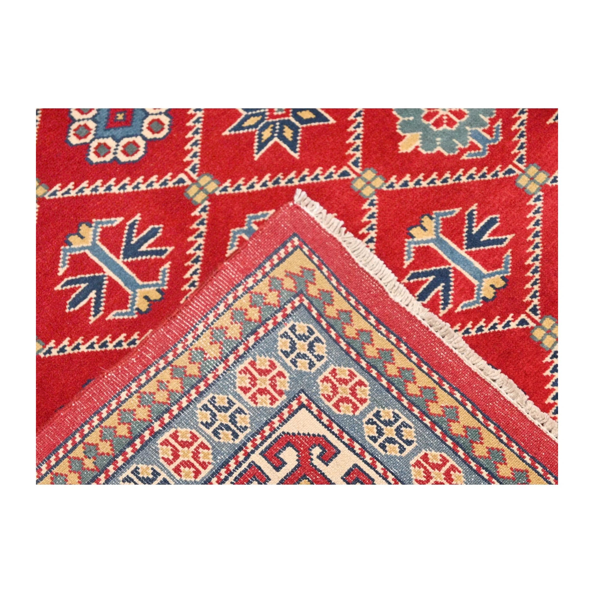 Folded corner detail of Afghan Shirvan wool rug showing patterned border and reverse weave, 221 x 159 cm