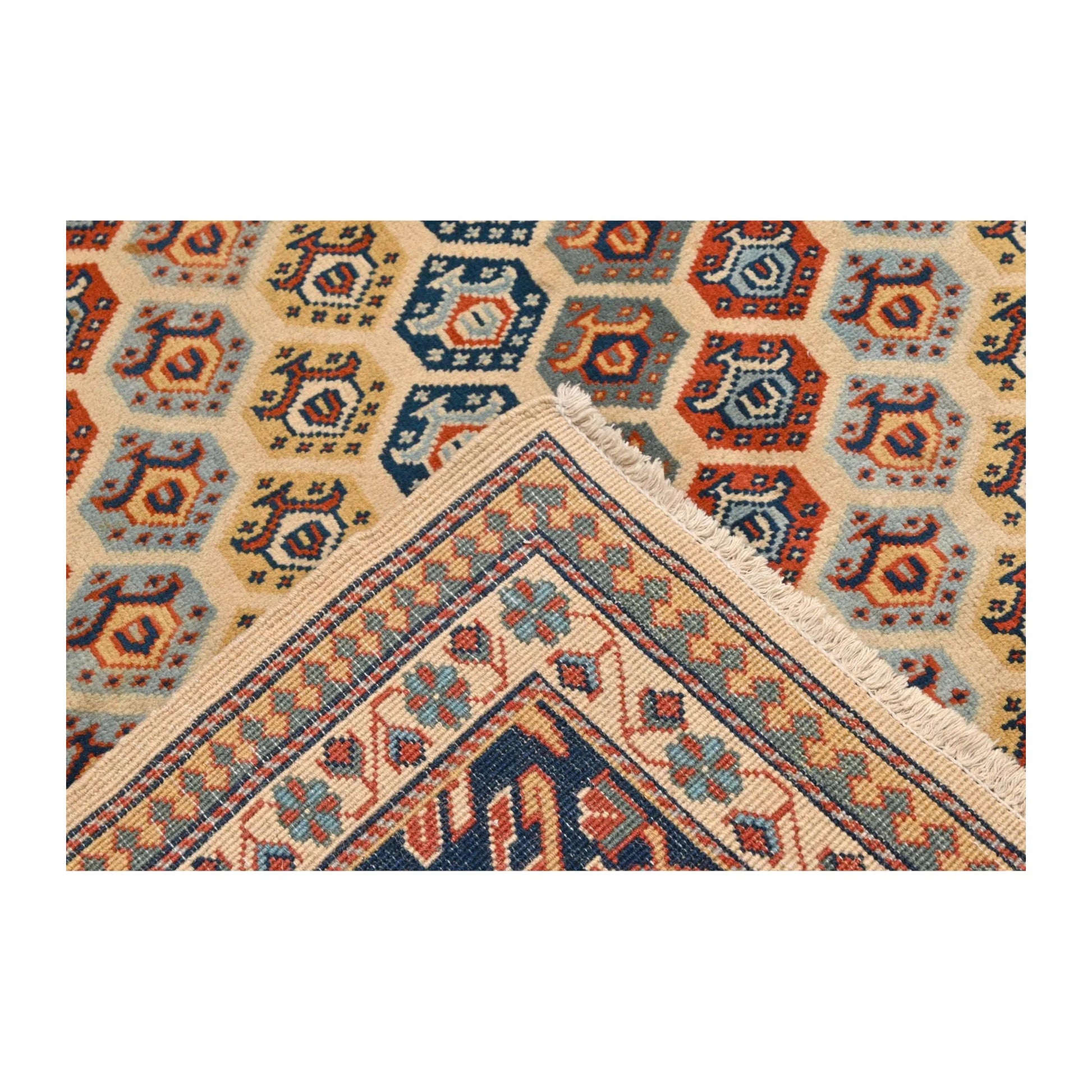 Reverse corner detail of Afghan Shirvan wool rug showing folded underside and patterned border, 243 x 165 cm