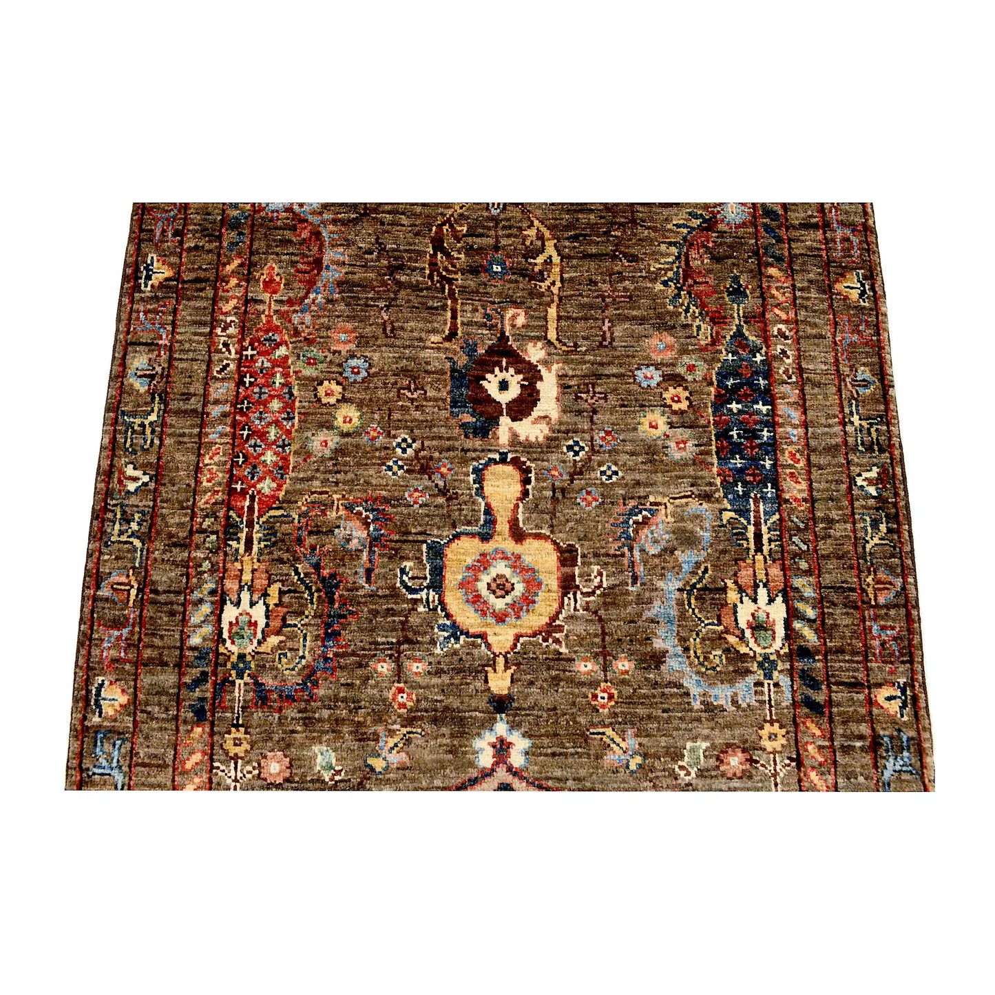 Central floral field detail of Afghan Sultani wool rug showing bronze-brown ground, ornamental motifs and muted blue accents