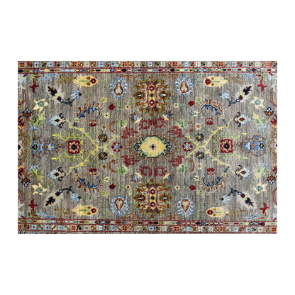 Field detail of Afghan Sultani rug showing mirror-balanced floral-geometric and pictorial motifs on grey-green