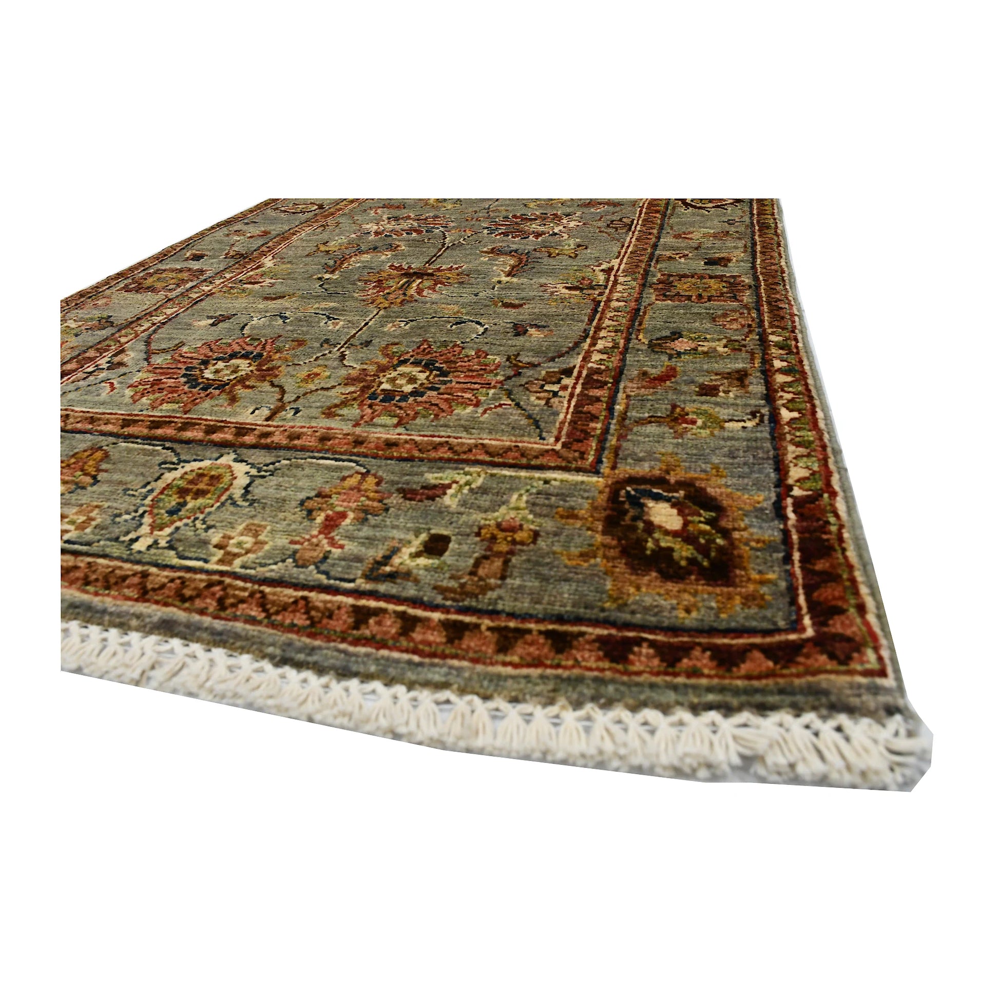 Angled corner and fringe view of Afghan Sultani wool runner rug showing muted sage field, warm border detail and light fringe