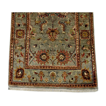 End field and border detail of Afghan Sultani hand-knotted wool runner rug showing floral motifs and framed border