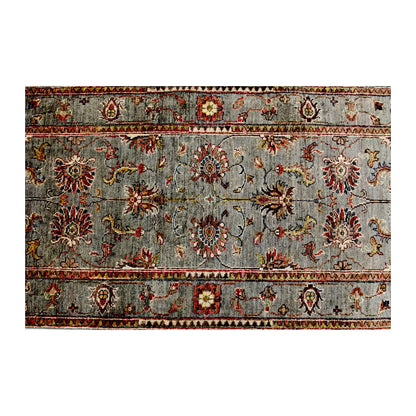 Length field detail of Afghan Sultani wool runner rug showing muted sage ground, floral vine pattern and border detail