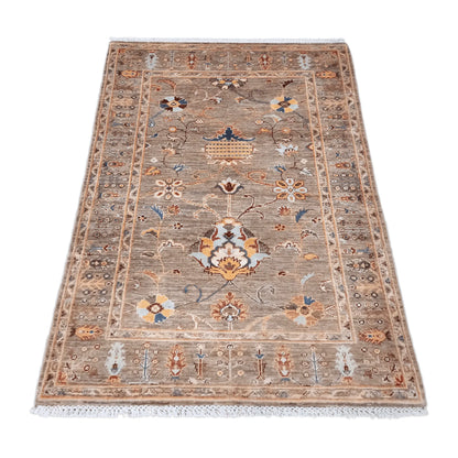 Angled view of Afghan Sultani wool rug with layered patterned borders, 157 x 101 cm