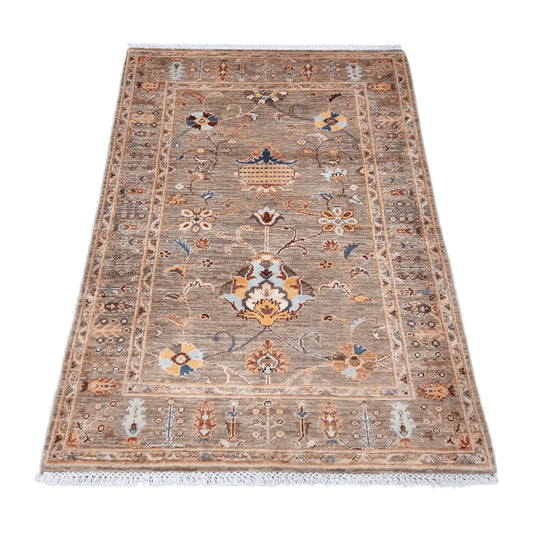 Angled view of Afghan Sultani wool rug with layered patterned borders, 157 x 101 cm