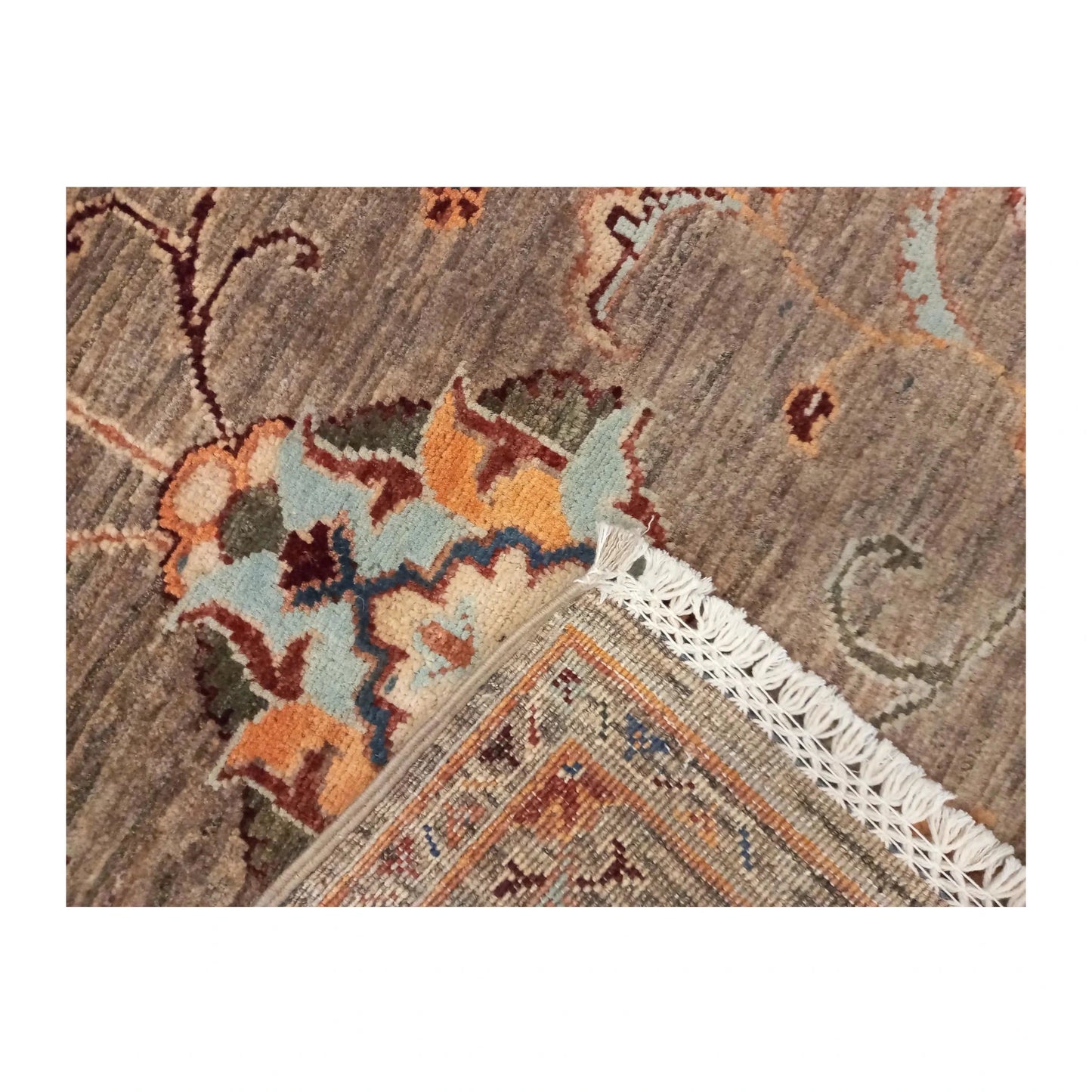 Folded-corner detail of Afghan Sultani wool rug showing fringe and reverse weave, 157 x 101 cm