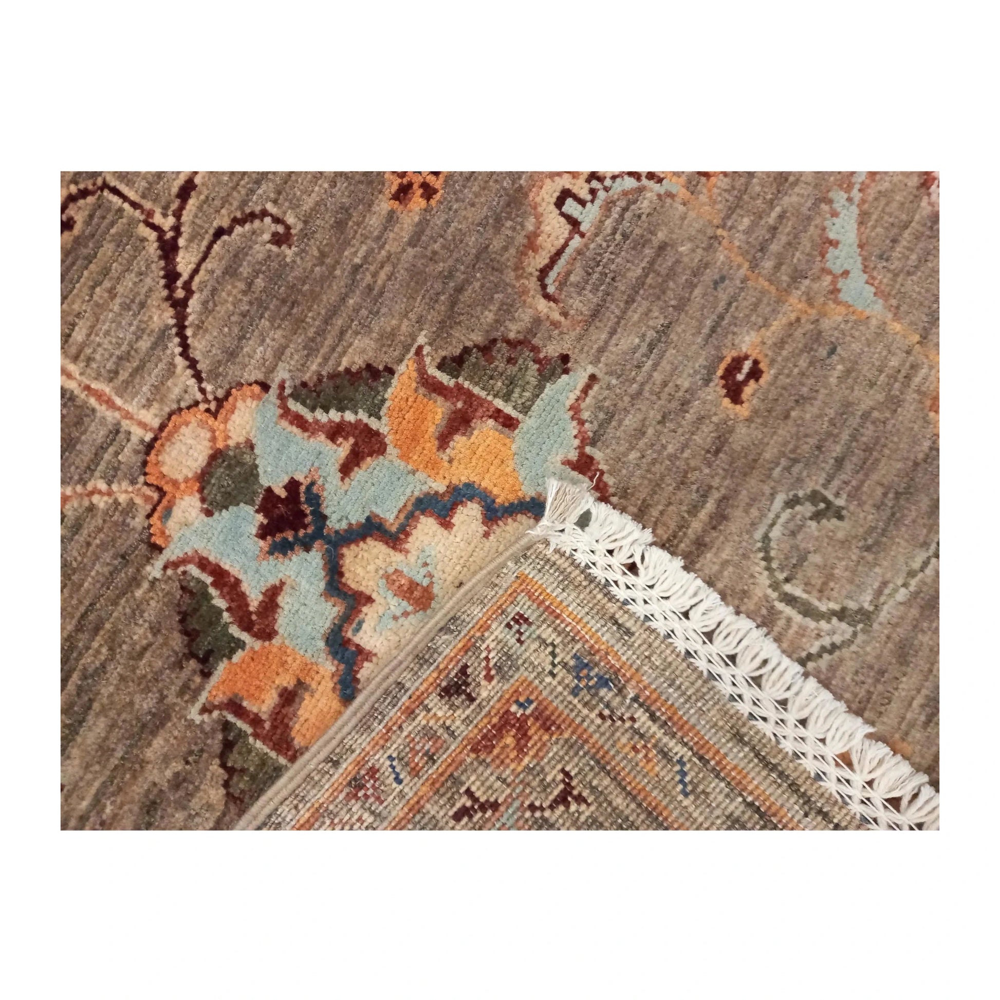 Folded-corner detail of Afghan Sultani wool rug showing fringe and reverse weave, 157 x 101 cm