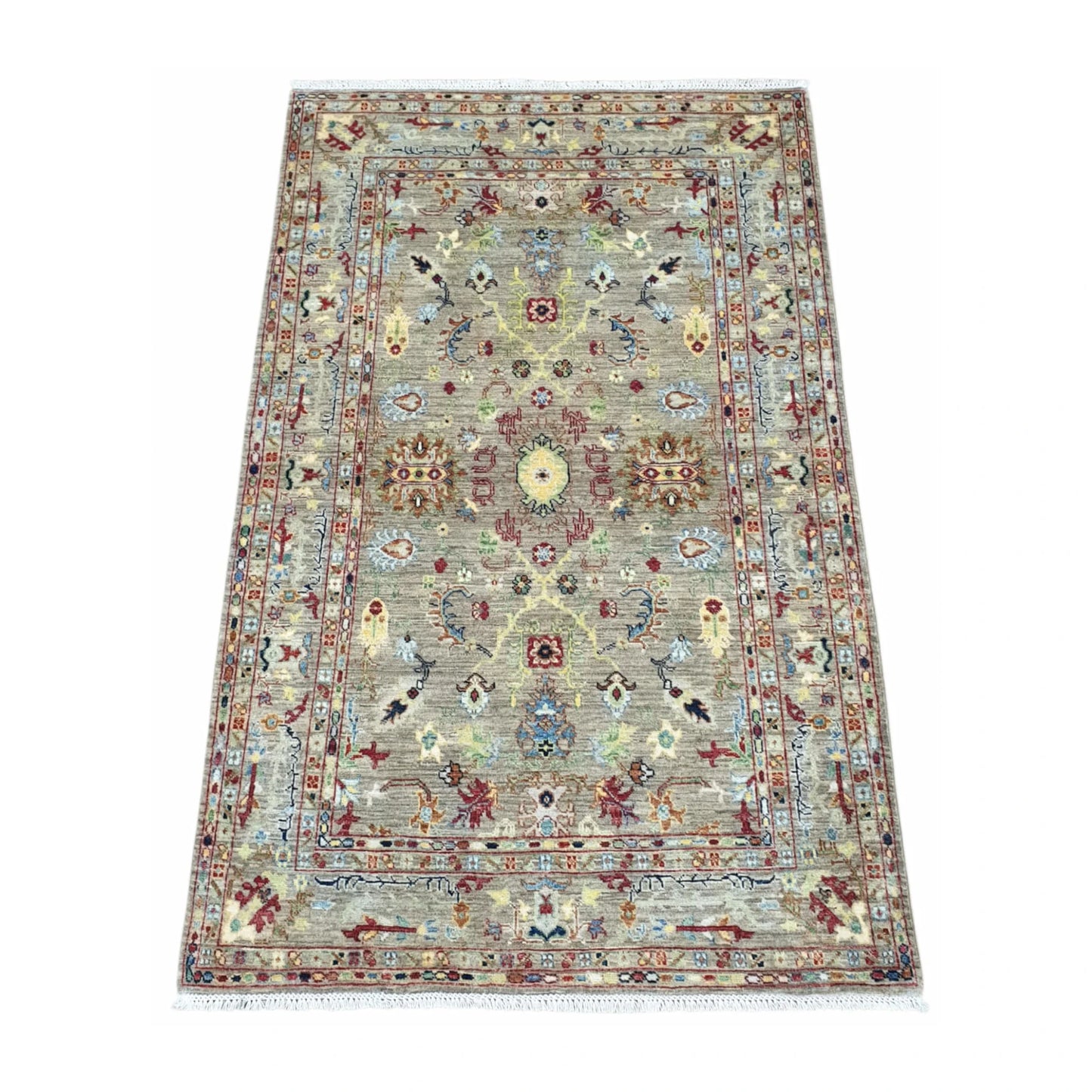 Angled view of Afghan Sultani wool rug with layered borders and pale blue accents, 185 x 119 cm
