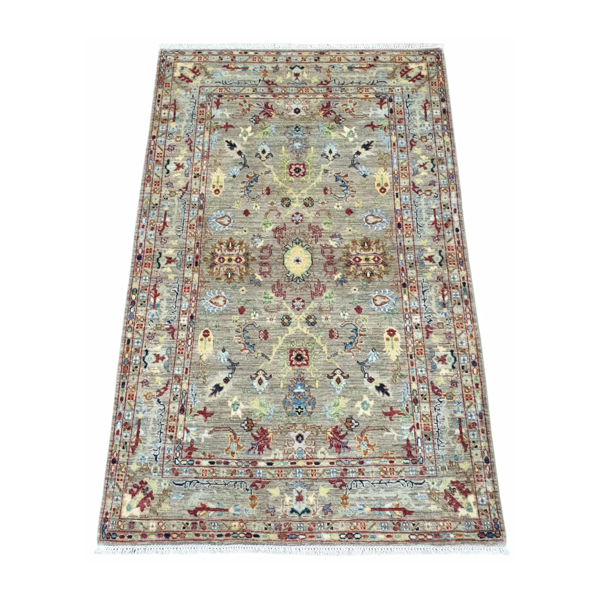 Angled view of Afghan Sultani wool rug with layered borders and pale blue accents, 185 x 119 cm