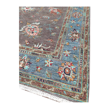 Blue border detail of Afghan Sultani wool rug with floral motifs and fringe edge