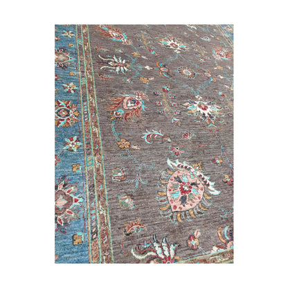 Angled detail of Afghan Sultani hand-knotted rug showing wool pile and multicolour floral motifs