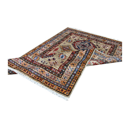 Folded view of Afghan Super Kazak wool rug showing its triple-medallion field, layered borders and fringe