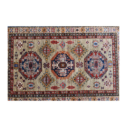 Field detail of Afghan Super Kazak rug showing three medallions and smaller diamond motifs on striated beige