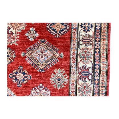 Field and side-border detail of Afghan Super Kazak rug showing multicoloured diamond medallions and layered geometric borders