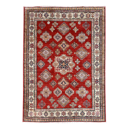 Full view of Afghan Super Kazak hand-knotted wool rug with a red field, diamond medallions and broad ivory border, 246 x 185 cm