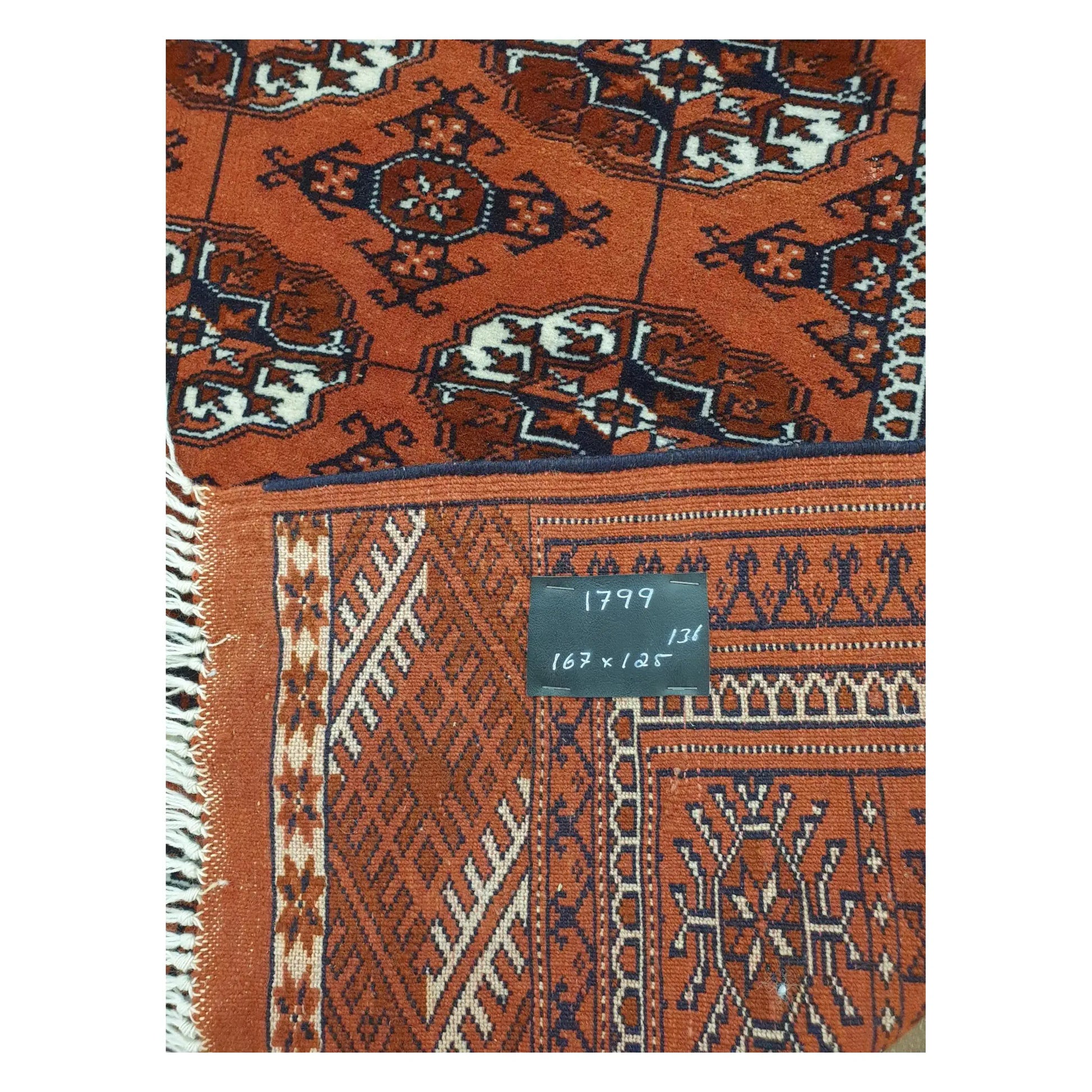 Back detail of Afghan Turkmen Tekke hand-knotted wool rug showing weave and size label