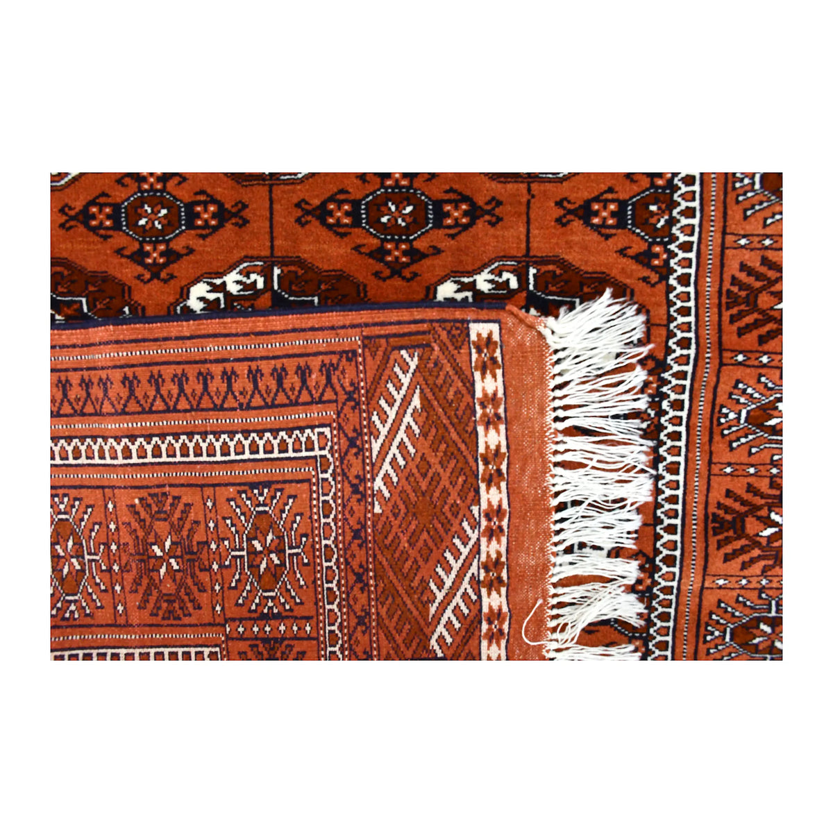 Folded-corner detail of Afghan Turkmen Tekke rug showing its reverse weave, border and ivory fringe