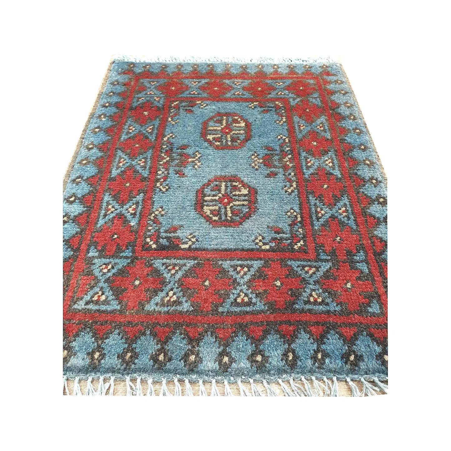 Afghan Turkoman blue wool rug detail showing twin gul medallions, blue field and red tribal border