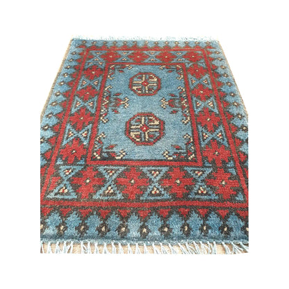 Afghan Turkoman blue wool rug detail showing twin gul medallions, blue field and red tribal border