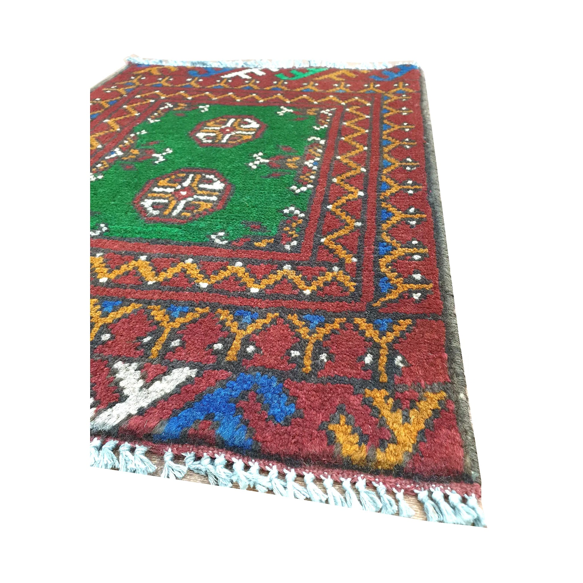 Fringe and border detail of Afghan Turkoman green wool rug showing red border, blue accents and tribal motifs