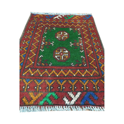 Afghan Turkoman green wool rug detail showing twin gul medallions, green field and multicolour border pattern