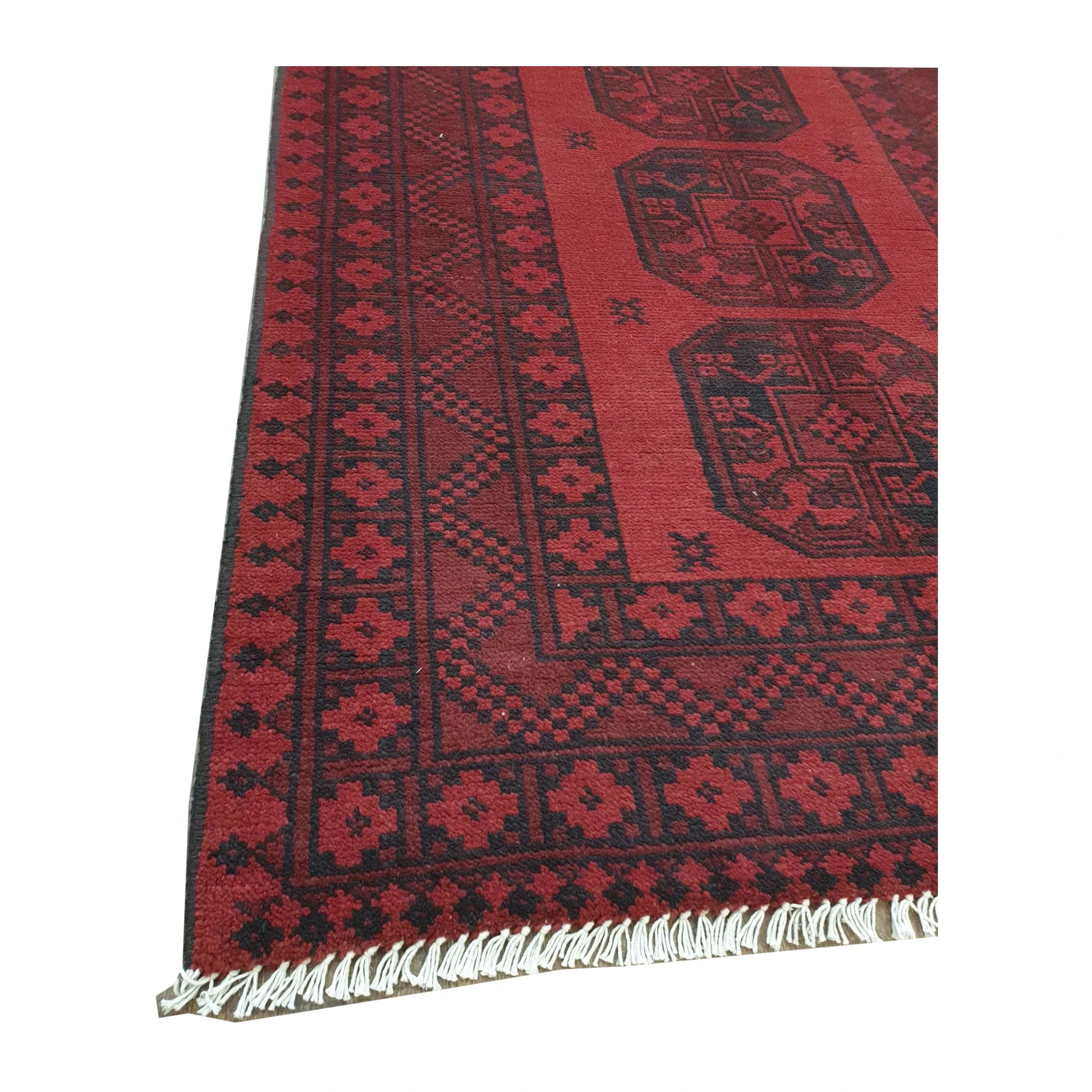 Border and fringe detail of Afghan Turkoman hand-knotted wool rug showing red and black geometric pattern