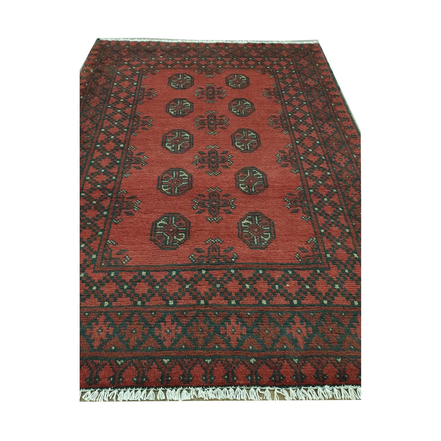 Angled full view of Afghan Turkoman wool rug showing red field, black border and cream geometric details