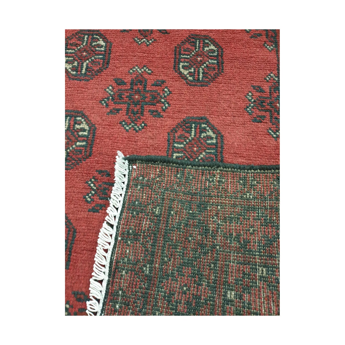 Reverse weave detail of Afghan Turkoman hand-knotted wool rug showing back construction and edge finish