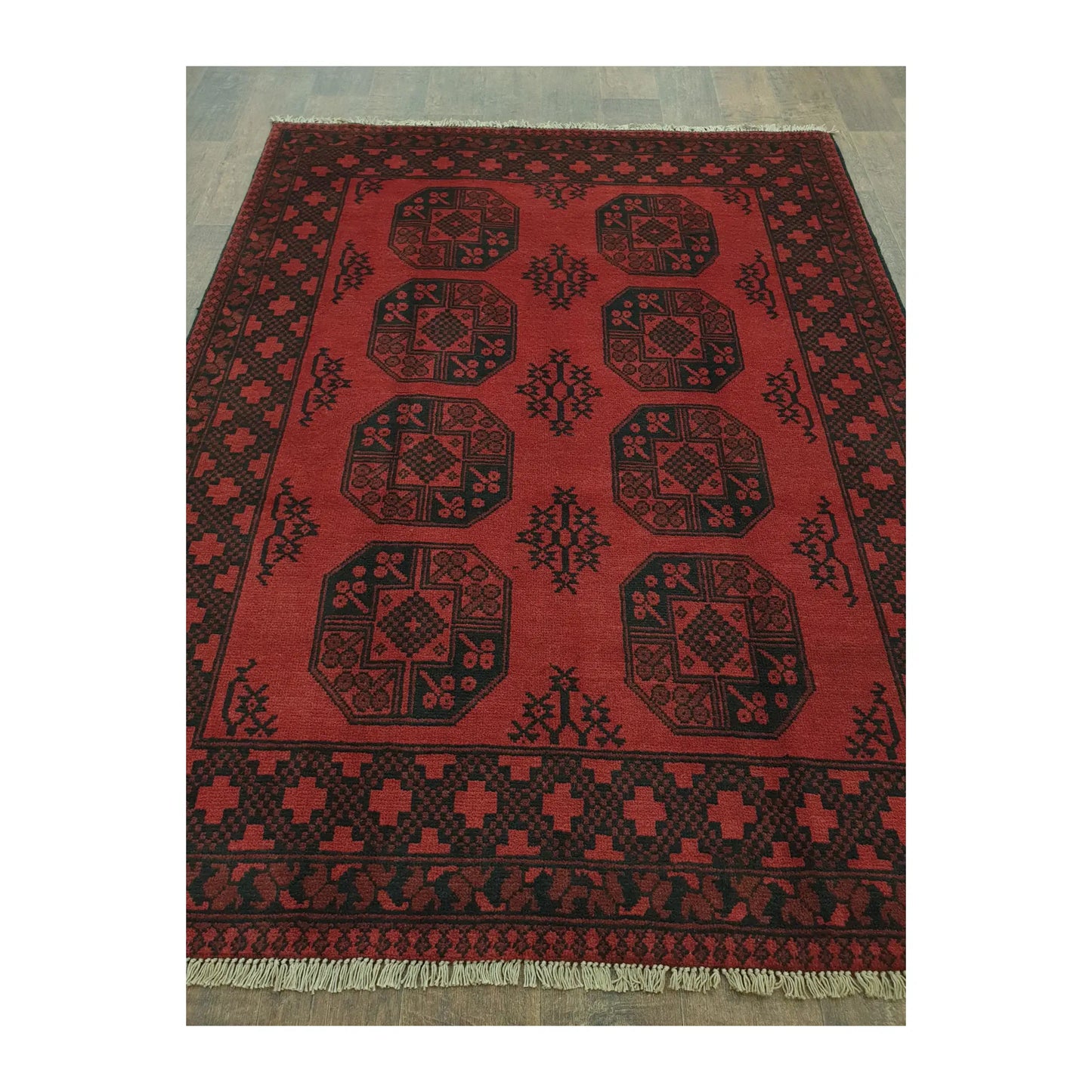 Angled full view of Afghan Turkoman hand-knotted rug showing octagonal gul motifs