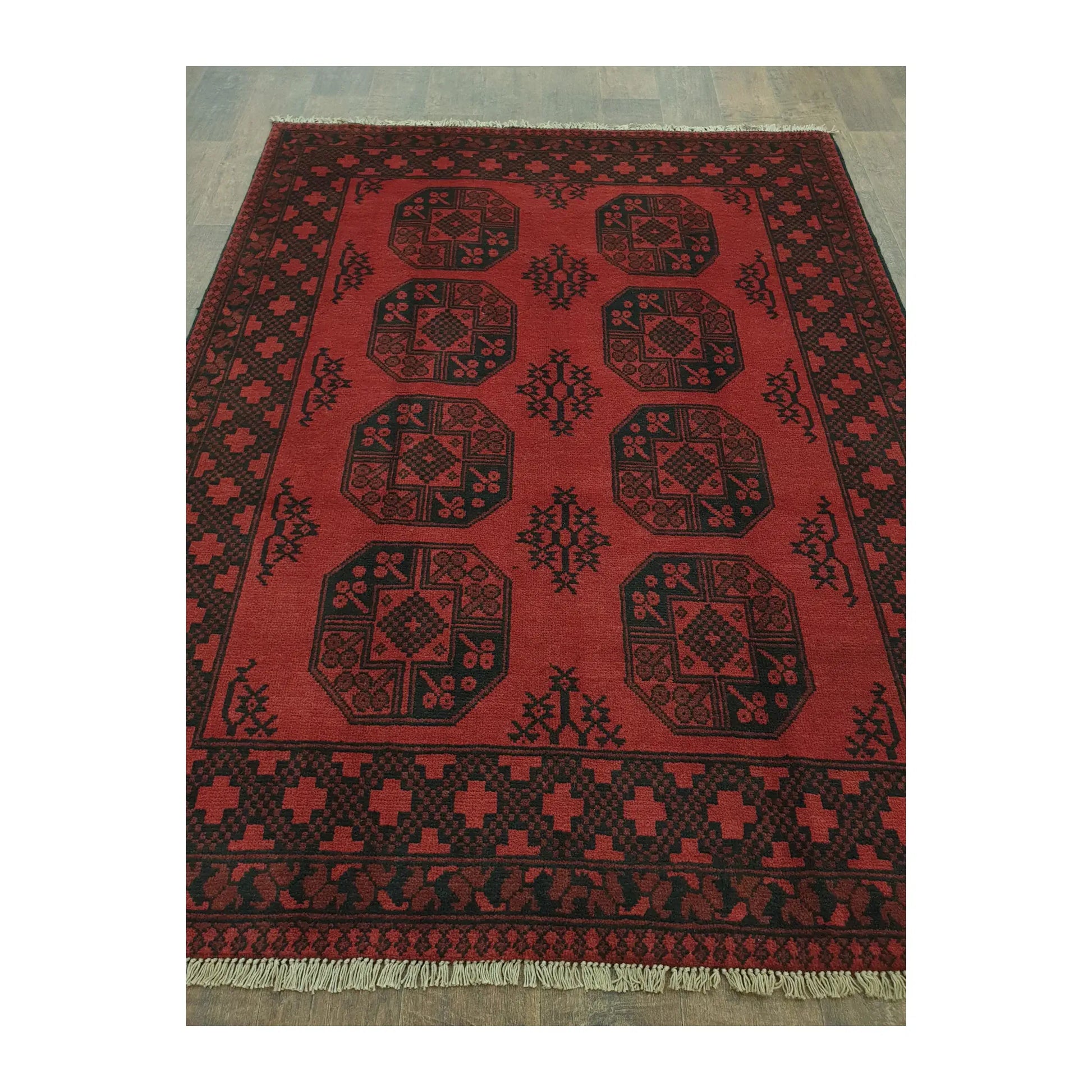 Angled full view of Afghan Turkoman hand-knotted rug showing octagonal gul motifs