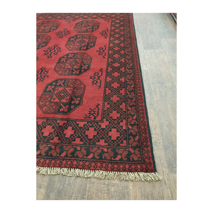 Border and fringe detail of Afghan Turkoman wool rug with red geometric pattern