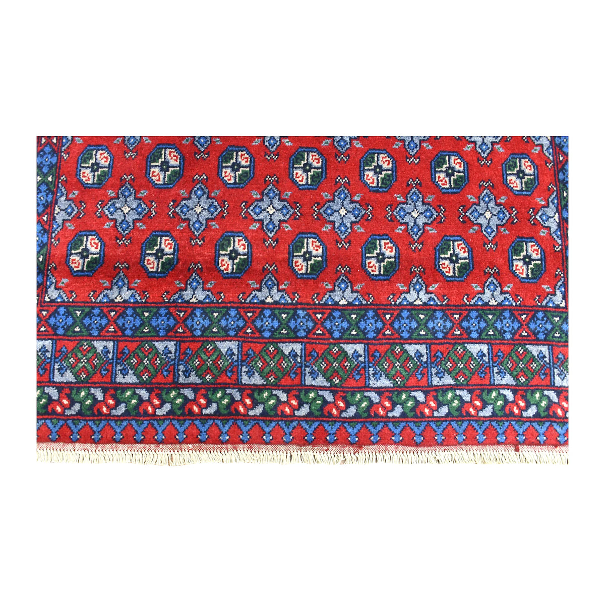 Fringe-end detail of Afghan Turkoman rug showing blue geometric bands, a green patterned border and red field
