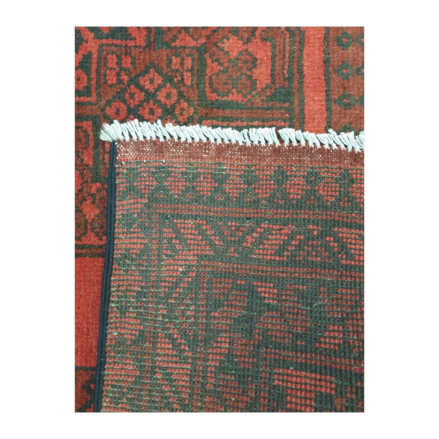 Reverse-weave detail of Afghan Turkoman wool rug showing back structure, fringe and hand-knotted pattern