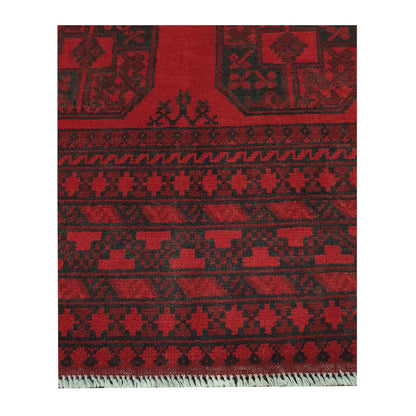 Border and fringe detail of Afghan Turkoman hand-knotted wool rug showing red pile and dark tribal pattern