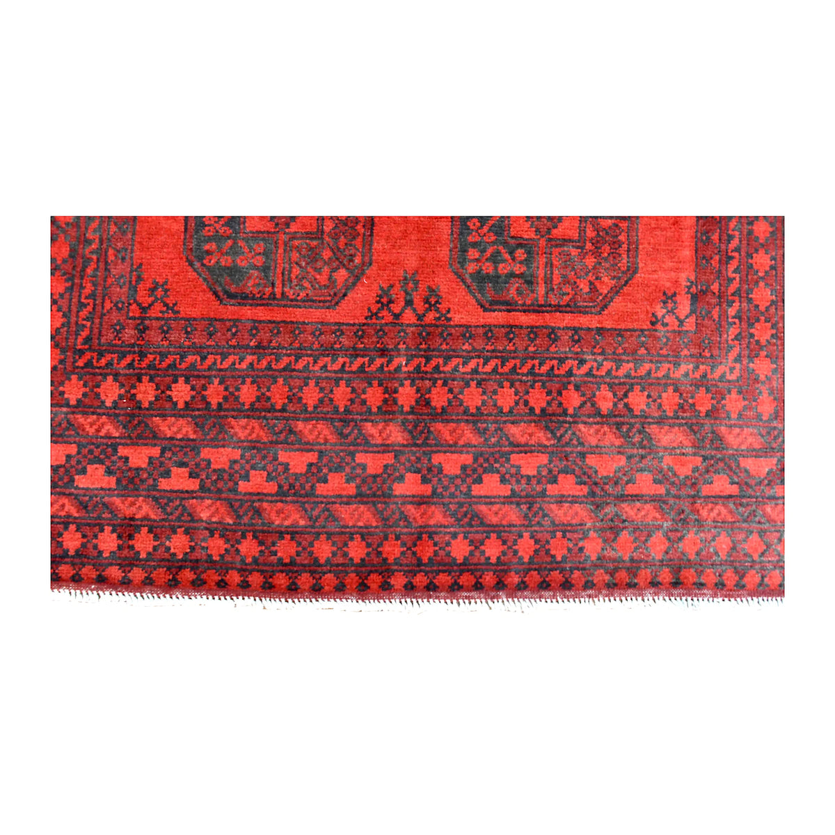 Fringe-end detail of Afghan Turkoman rug showing rows of small geometric motifs along the red and dark border