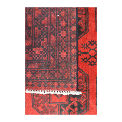 Folded-corner detail of Afghan Turkoman rug showing the patterned reverse weave, red front and white fringe