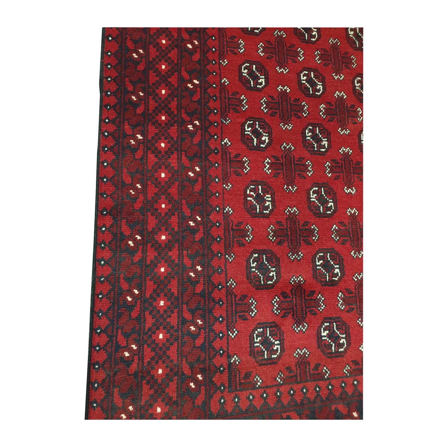 Border and field detail of Afghan Turkoman wool rug showing red pile, dark charcoal motifs and ivory accents